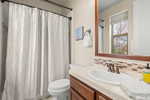 bathroom with backsplash, toilet, walk in shower, and vanity