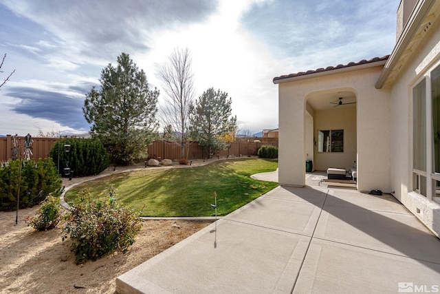 view of yard featuring a patio area and ceiling fan