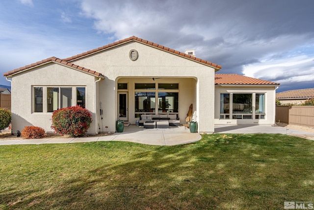 back of house with a patio area, outdoor lounge area, and a lawn