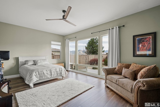 bedroom with dark wood-type flooring, access to exterior, and ceiling fan