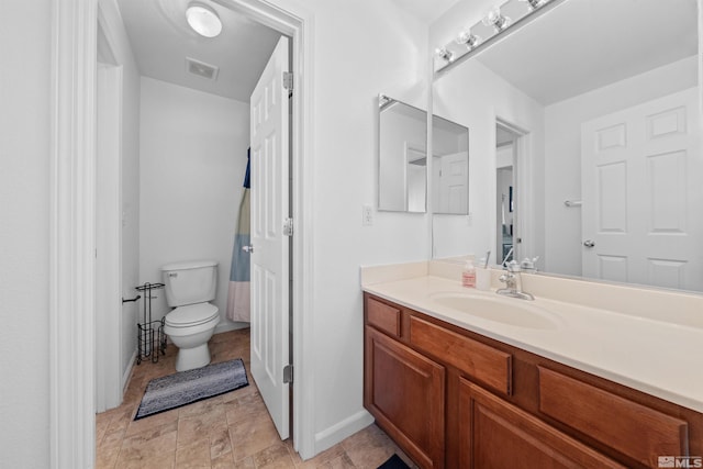 bathroom with toilet and vanity