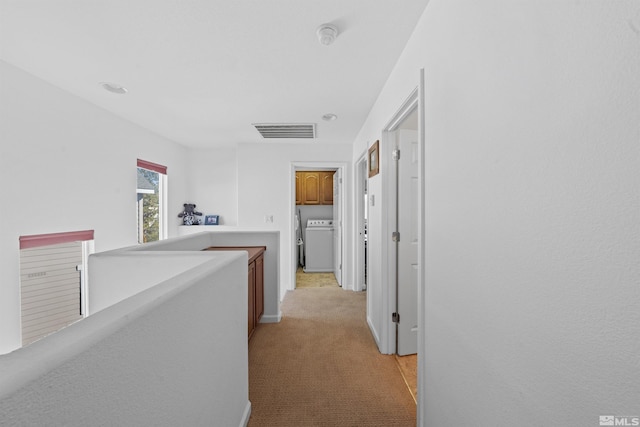 hall with light colored carpet