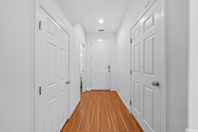 hallway with light hardwood / wood-style flooring