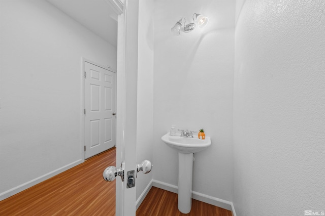 bathroom with wood-type flooring