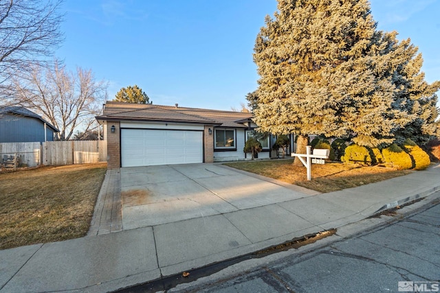 view of front of home featuring a garage and a front yard