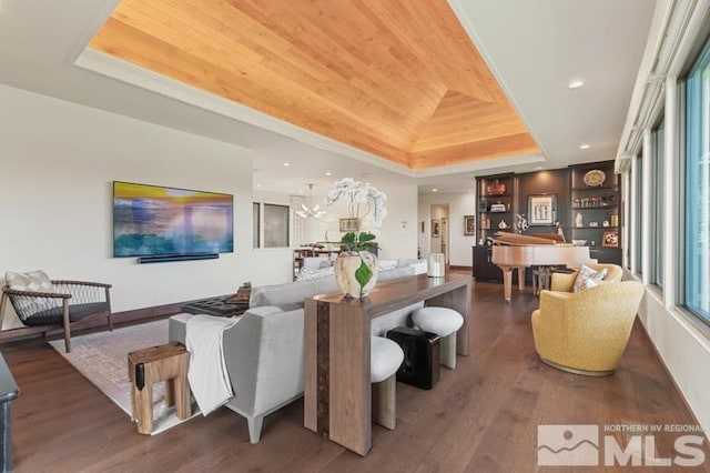 living room featuring hardwood / wood-style flooring, a tray ceiling, built in features, and wooden ceiling