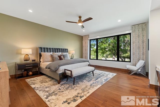 bedroom with hardwood / wood-style flooring and ceiling fan