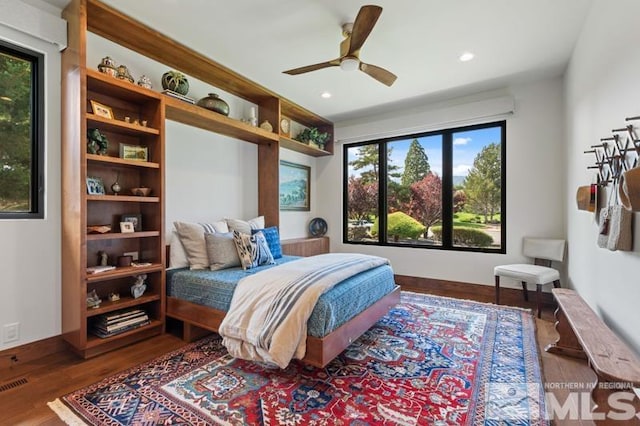 bedroom with dark hardwood / wood-style floors and ceiling fan