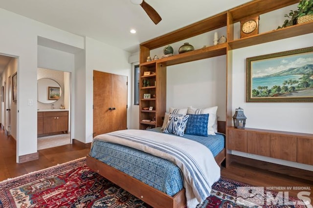 bedroom featuring ceiling fan, ensuite bath, and dark wood-type flooring