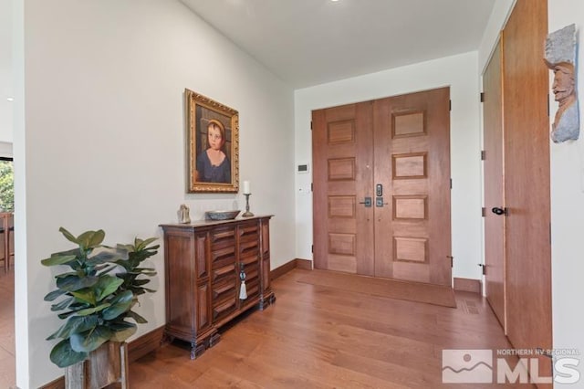 foyer entrance with light hardwood / wood-style flooring