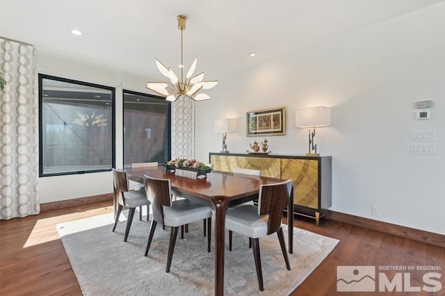 dining space featuring a notable chandelier and dark wood-type flooring