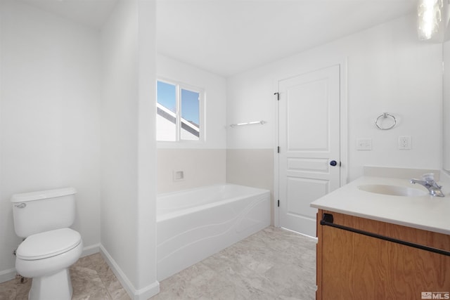 bathroom featuring vanity, toilet, and a tub to relax in