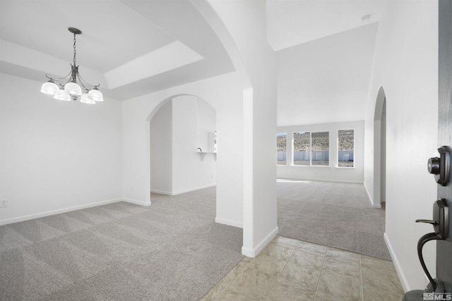 interior space featuring an inviting chandelier and a tray ceiling