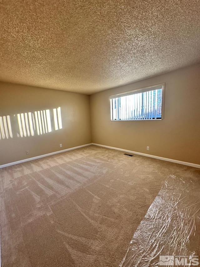 spare room featuring carpet floors