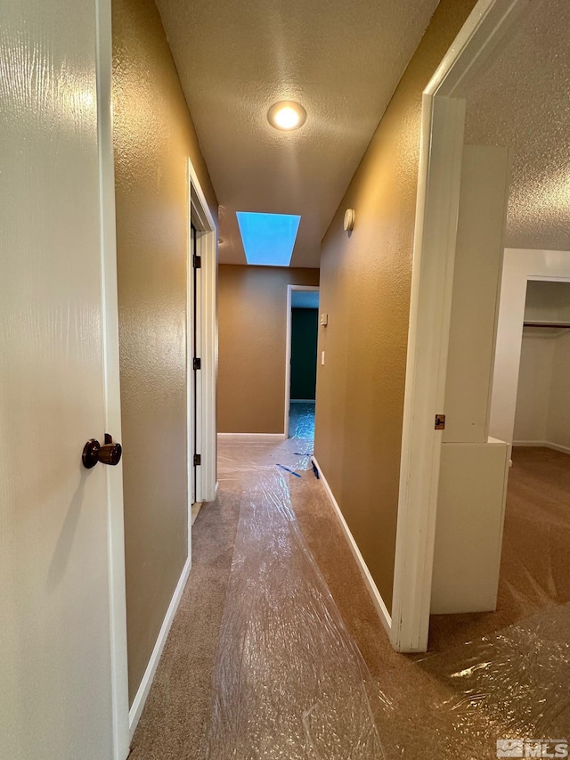 hallway featuring a textured ceiling