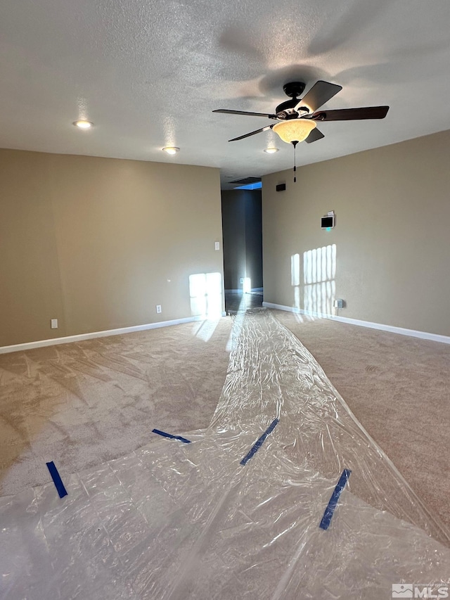 carpeted spare room with a textured ceiling