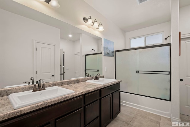 bathroom with bath / shower combo with glass door, tile patterned floors, and vanity