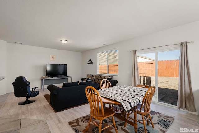 dining space with light hardwood / wood-style flooring