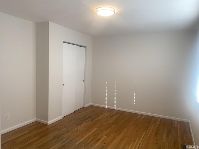 unfurnished room featuring dark hardwood / wood-style flooring