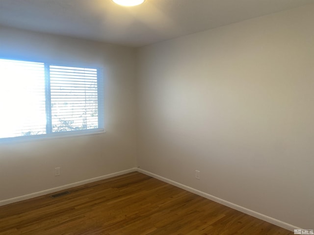 empty room featuring dark wood-type flooring