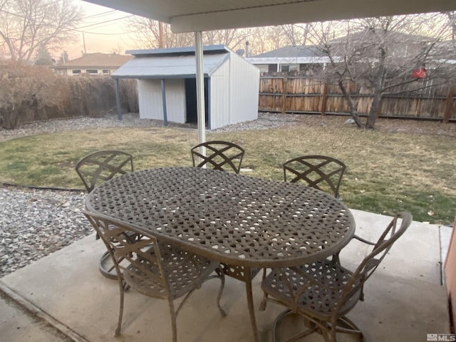 patio terrace at dusk with a yard and a shed