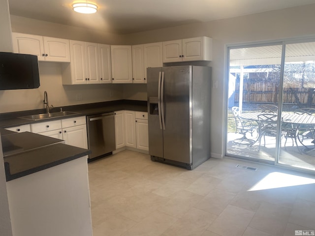 kitchen with sink, white cabinets, and stainless steel appliances