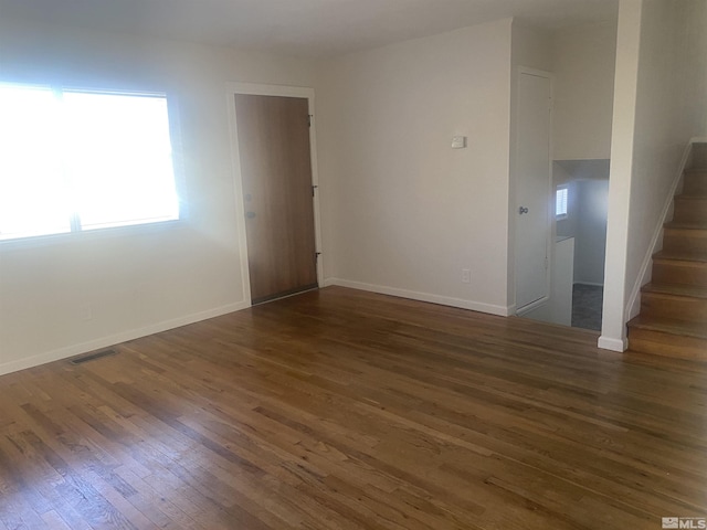 spare room featuring dark hardwood / wood-style flooring