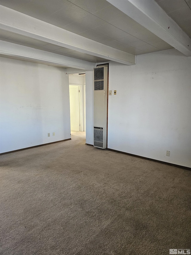 carpeted spare room featuring beamed ceiling