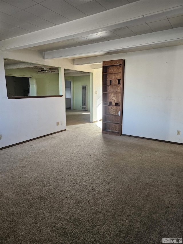 empty room featuring carpet flooring and beam ceiling
