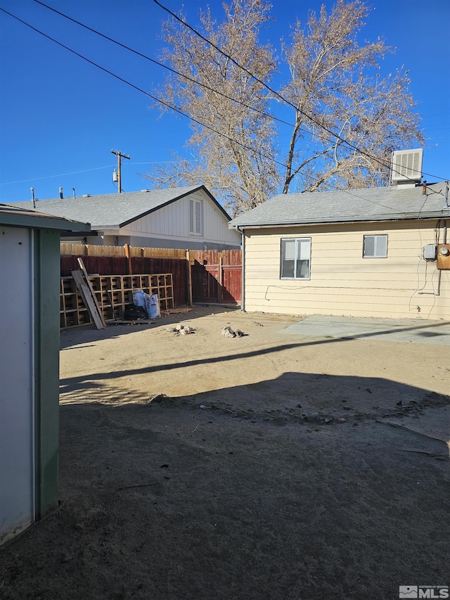 rear view of house featuring central AC