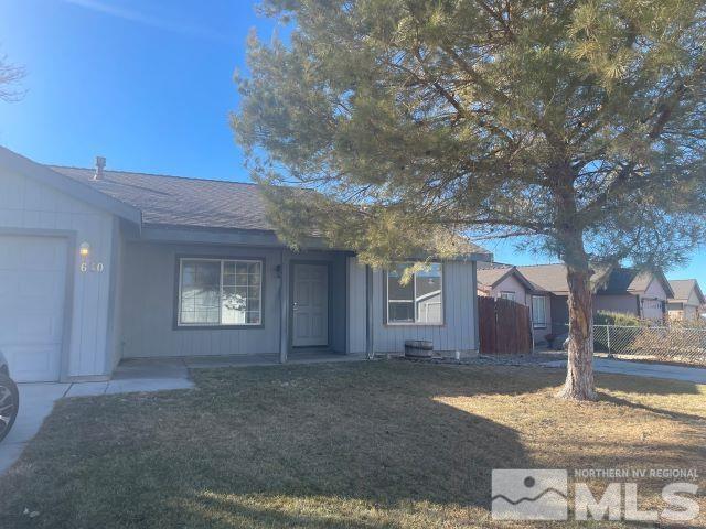 ranch-style home with a garage and a front lawn