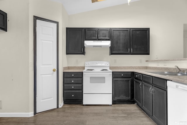 kitchen featuring lofted ceiling, sink, white appliances, and light hardwood / wood-style floors