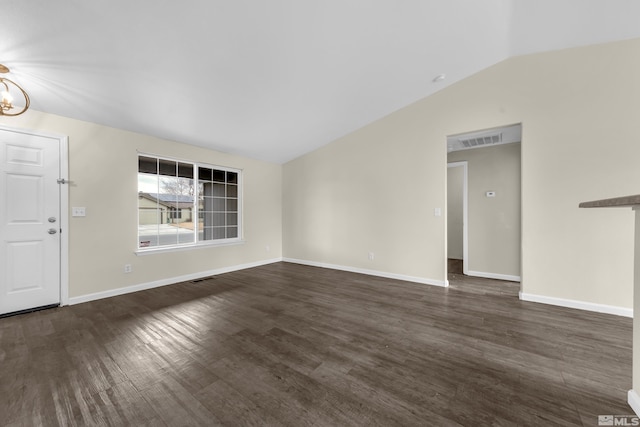 unfurnished living room featuring an inviting chandelier, lofted ceiling, and dark hardwood / wood-style flooring