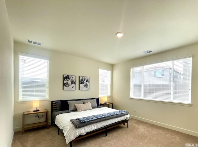 bedroom with light colored carpet