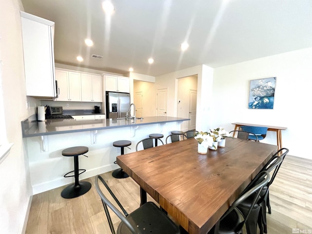 dining space featuring light wood-type flooring