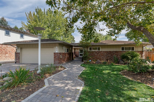 view of front of house with a front yard and a garage