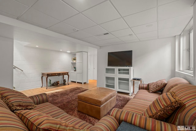 living room with a drop ceiling