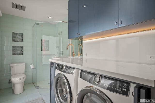 laundry area with separate washer and dryer, tile walls, sink, and light tile patterned flooring