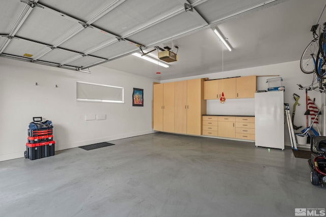 garage featuring a garage door opener and white fridge