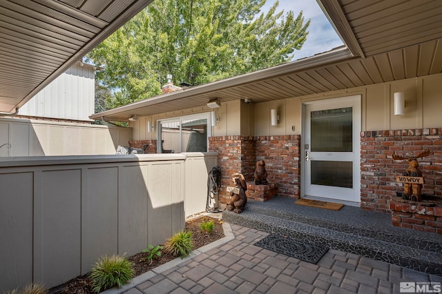 view of exterior entry featuring a patio
