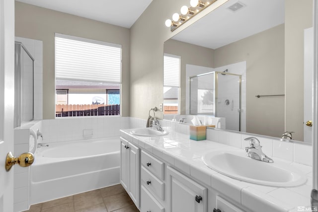 bathroom with independent shower and bath, tile patterned floors, and vanity