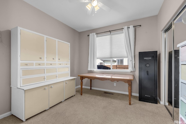 carpeted home office with ceiling fan