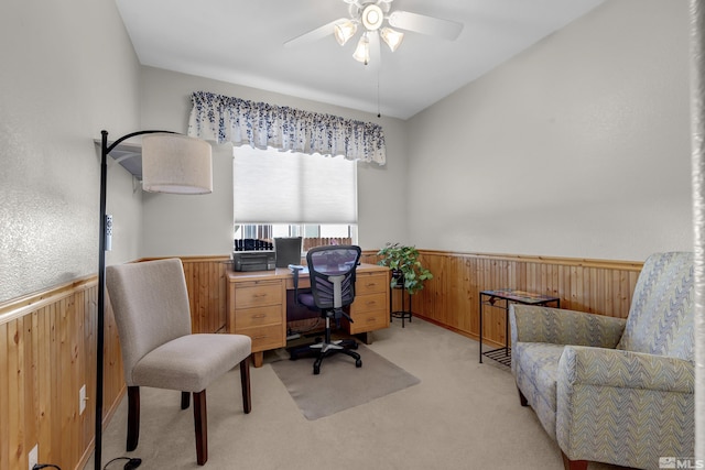 office with light colored carpet, wooden walls, and ceiling fan