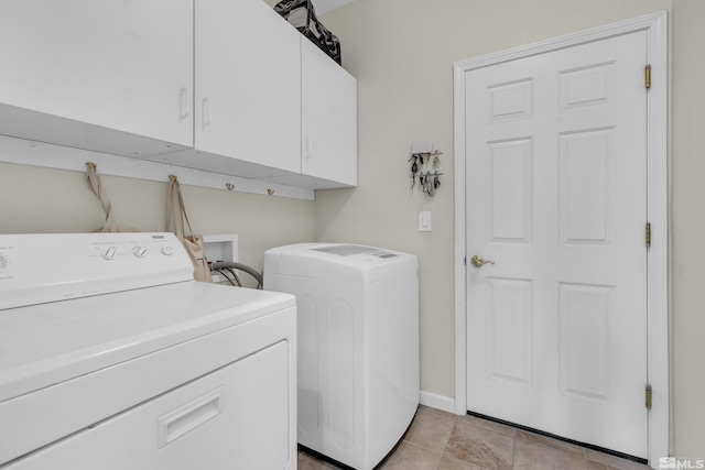 laundry room featuring cabinets and washer and dryer