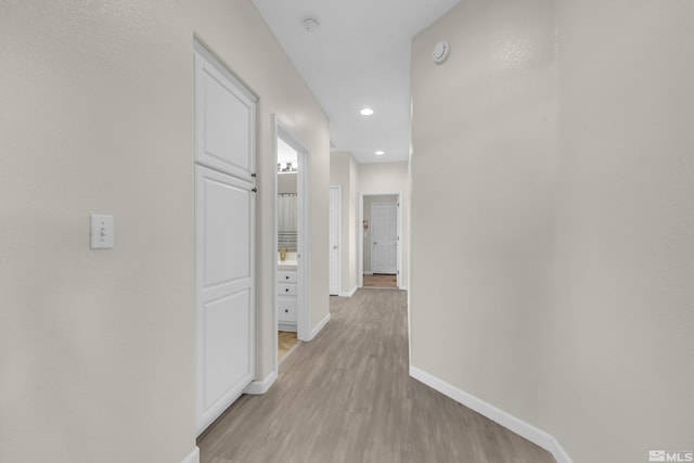 corridor with light wood-type flooring