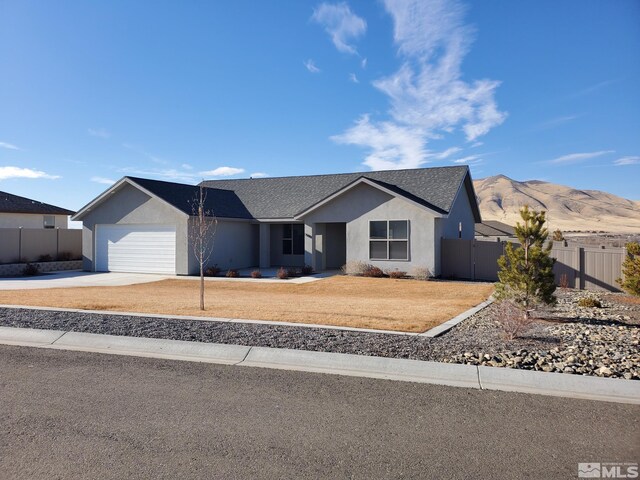 ranch-style home with a mountain view and a garage