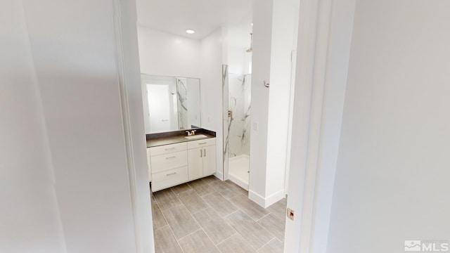 bathroom with vanity and a shower