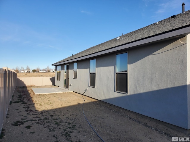 view of side of home featuring a patio