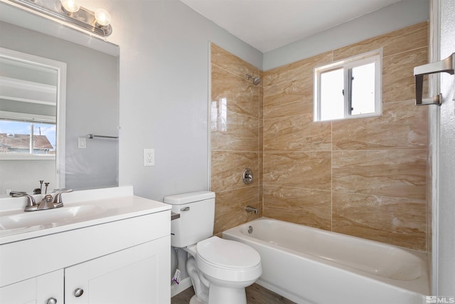 full bathroom with vanity, tiled shower / bath combo, plenty of natural light, and toilet