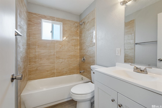 full bathroom with vanity, toilet, and tiled shower / bath